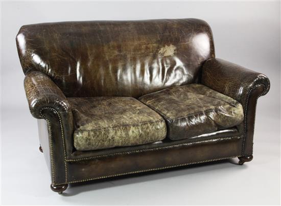 A brass studded brown leather two seat settee, W.4ft 8in. H.2ft 10in. D.3ft 2in.